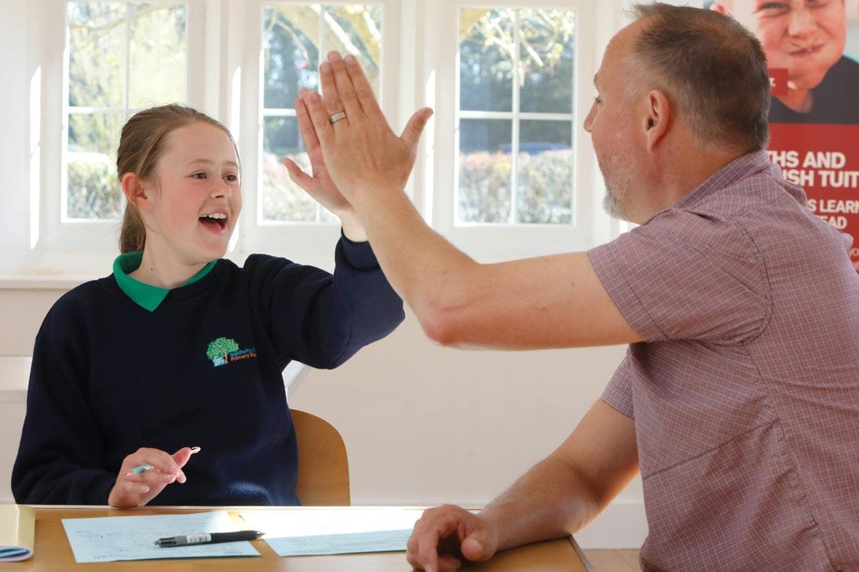 student high five after assessment