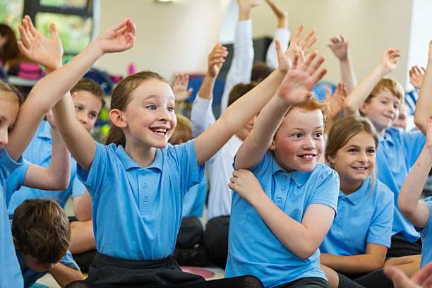 classroom children hands up